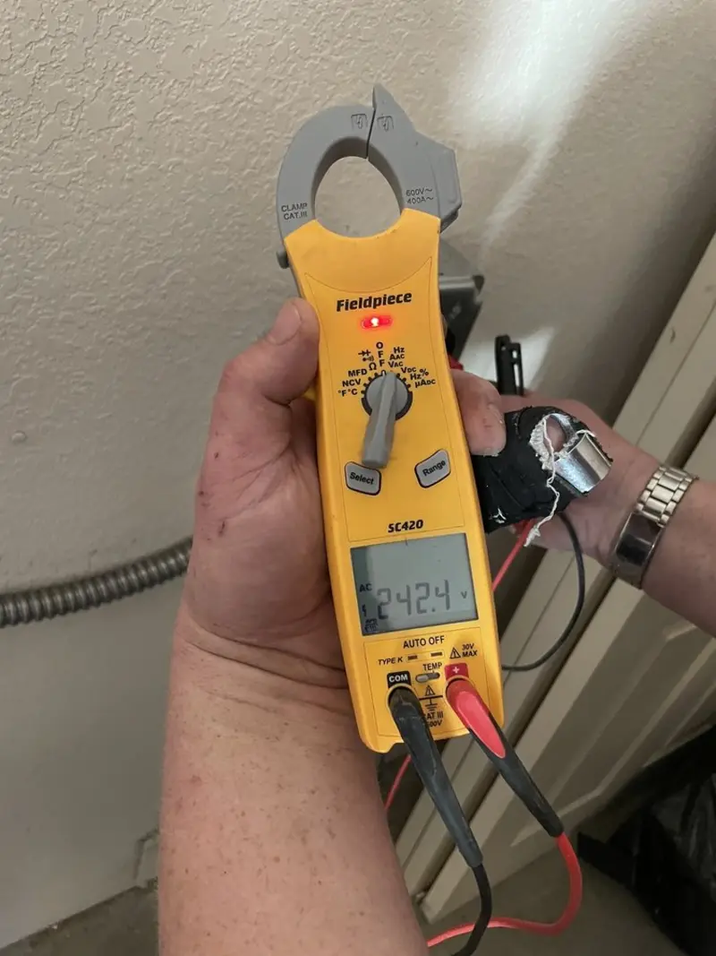 Voltage testing with clamp meter during Electrical Installation Services in Orlovista